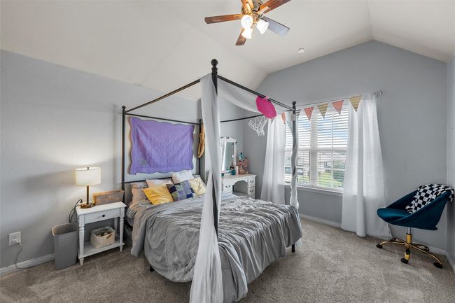 Bedroom with vaulted ceiling, carpet, and a ceiling fan | Image 23