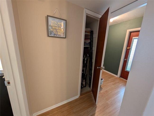 Linen closet and green Laundry room w/additional exterior door. | Image 14