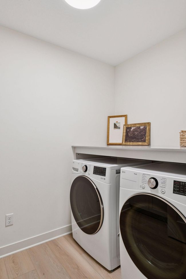 Upper level laundry room with folding counter, base cabinets and a sink (not shown). | Image 16