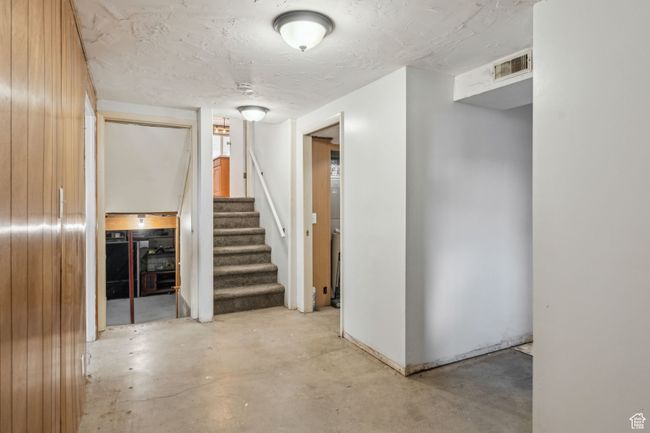Below grade area with wood walls, stairs, and visible vents | Image 24