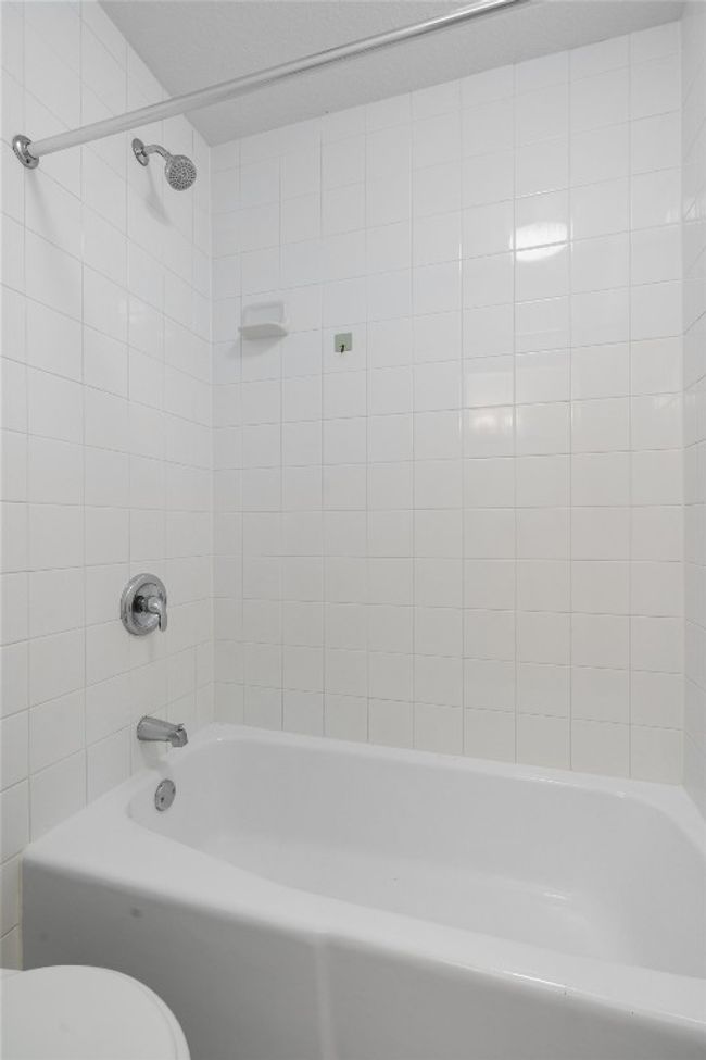 Bathroom featuring toilet and bathtub / shower combination | Image 24