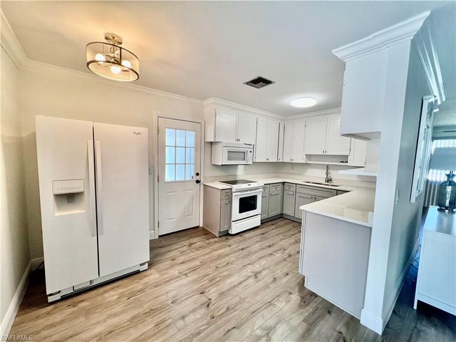 Kitchen with QUARTZ tops and newer cabinets. | Image 11