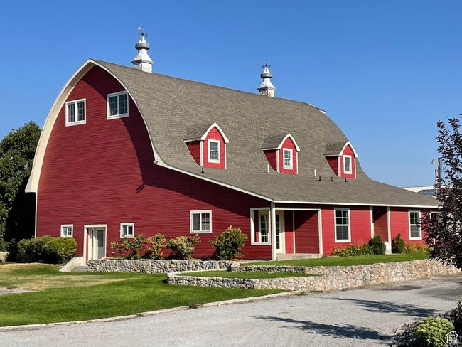 View of front of house with a chimney, a barn, a shingled roof, and covered porch | Image 4