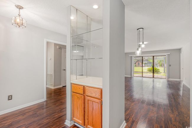 Interior space featuring baseboards, visible vents, and dark wood-style floors | Image 10