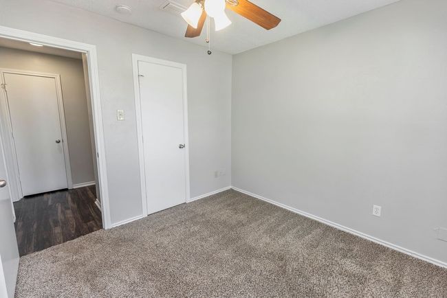 Unfurnished bedroom featuring carpet, baseboards, and ceiling fan | Image 24