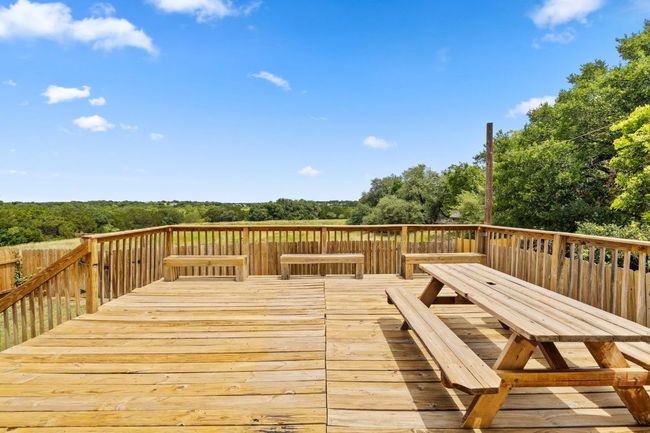 Wooden terrace featuring outdoor dining area | Image 38