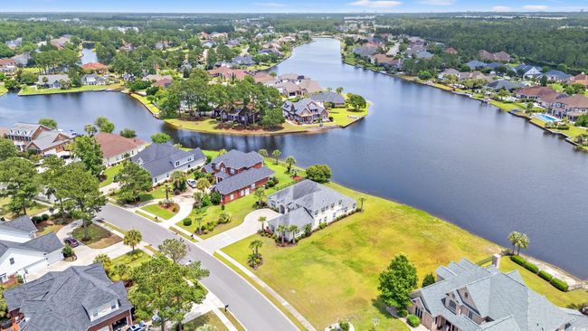 Aerial view of residential area with a large body of water | Image 9