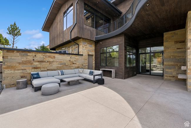 View of patio / terrace featuring a balcony and an outdoor living space with a fireplace | Image 125