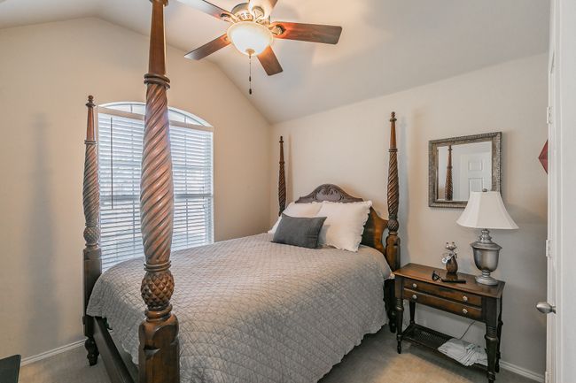 Second bedroom featuring vaulted ceiling, and a ceiling fan. | Image 13