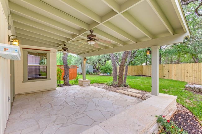Fenced backyard with ceiling fan, a patio, and a wall mounted air conditioner | Image 27