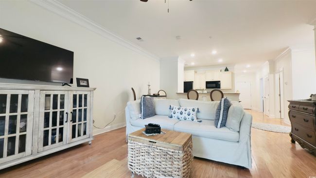 Living room featuring crown molding, ceiling fan, light wood finished floors, and recessed lighting | Image 32