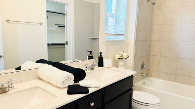 Full bathroom with double vanity and bathing tub / shower combination | Image 24