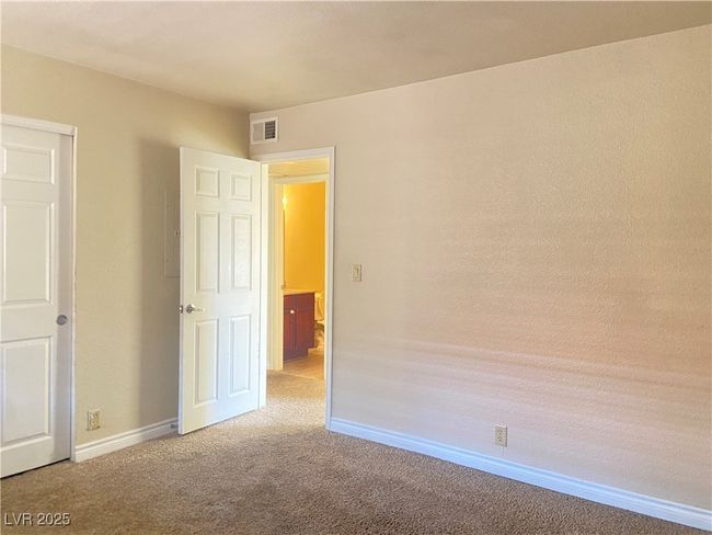 Empty room featuring light carpet, visible vents, and baseboards | Image 14