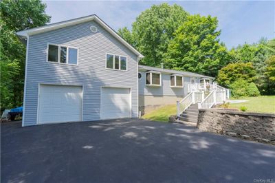 View of front facade with a garage | Image 1