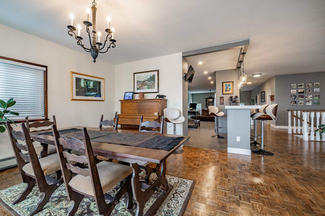 Dining area with a chandelier and baseboards | Image 10