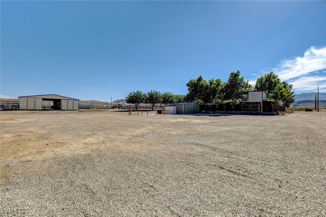 View of yard with a pole building and an outdoor structure | Image 48