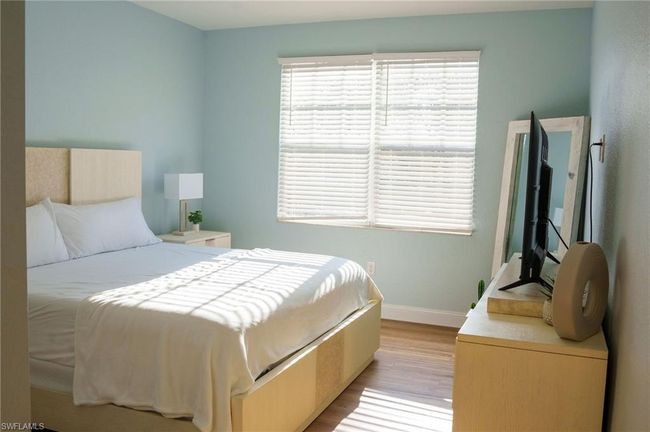 Bedroom with baseboards and light wood finished floors | Image 10