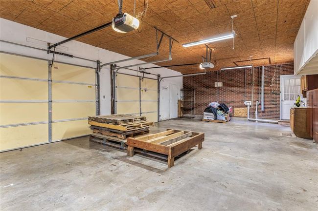 Garage featuring a garage door opener | Image 63