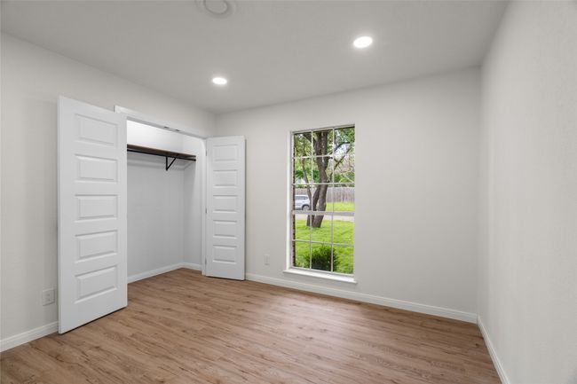 Unfurnished bedroom with light wood-style floors, baseboards, recessed lighting, and a closet | Image 21