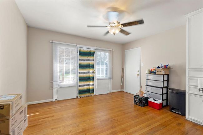 The kitchen is open to the dining/flex space. There is tall pantry that was built on-site. The door on the left leads to the garage. | Image 7