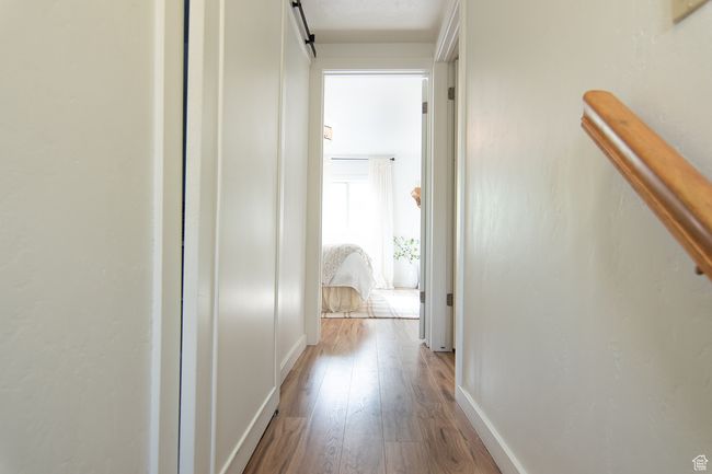 Hall featuring wood finished floors and baseboards | Image 11