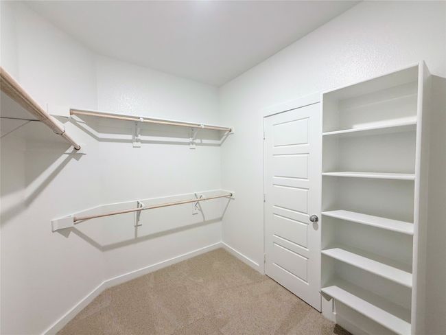 Spacious closet featuring carpet | Image 17