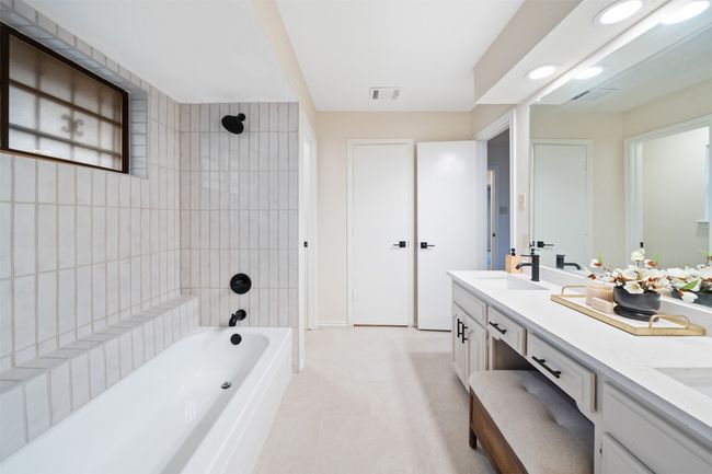 Full bathroom with a sink, shower / washtub combination and double vanity. | Image 15