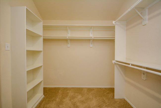 Master walk-in closet features shelving and so much space! | Image 20
