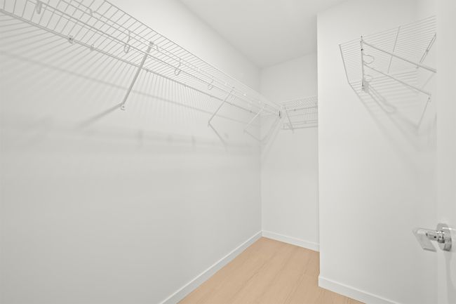 Spacious closet with light wood finished floors | Image 14