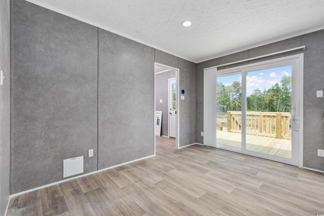 Empty room featuring wood finished floors and a textured ceiling | Image 17