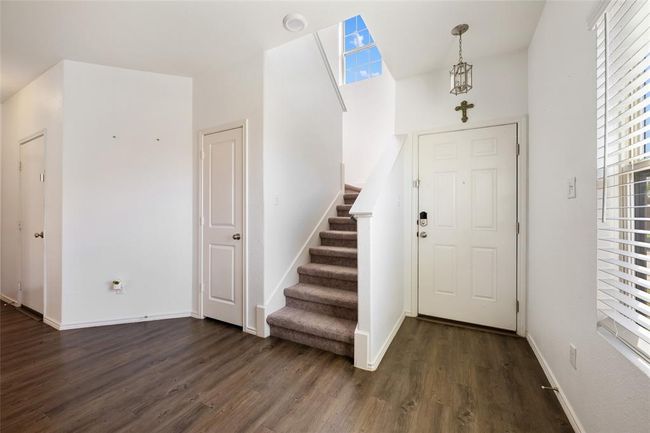 Entryway featuring dark wood-type flooring, healthy amount of natural light, and stairway | Image 27