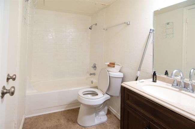Bathroom featuring shower combination, vanity, and light tile patterned floors | Image 7