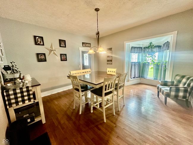 dining space with wood-type flooring and a textured ceiling | Image 19