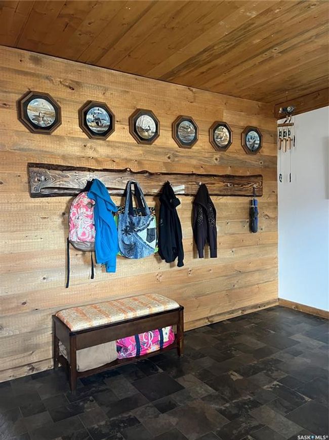 Mudroom featuring baseboards, wooden walls, and wood ceiling | Image 23