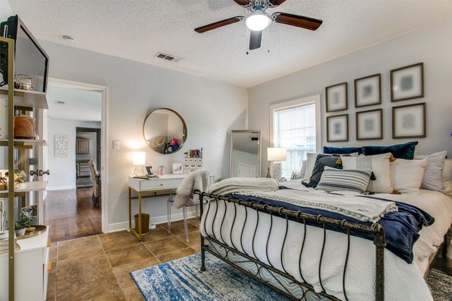Bedroom with visible vents, a ceiling fan, a textured ceiling, tile patterned flooring, and baseboards | Image 21