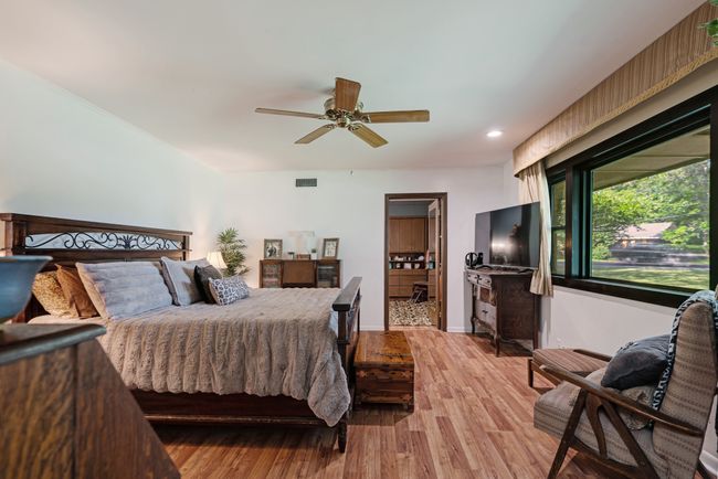Bedroom with light wood finished floors, recessed lighting, and ceiling fan | Image 18