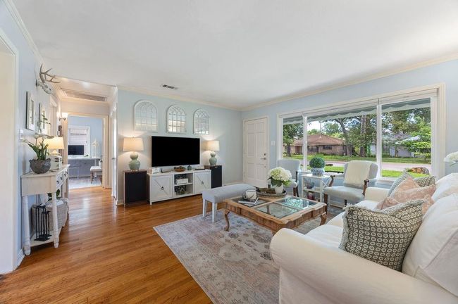 The living room allows for ample seating, and gets beautiful natural light every time of day. | Image 6
