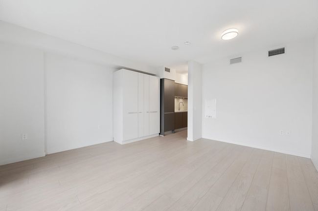 Spare room with visible vents and light wood-type flooring | Image 4