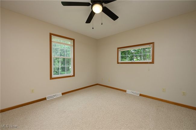 Carpeted empty room with plenty of natural light and a ceiling fan | Image 13