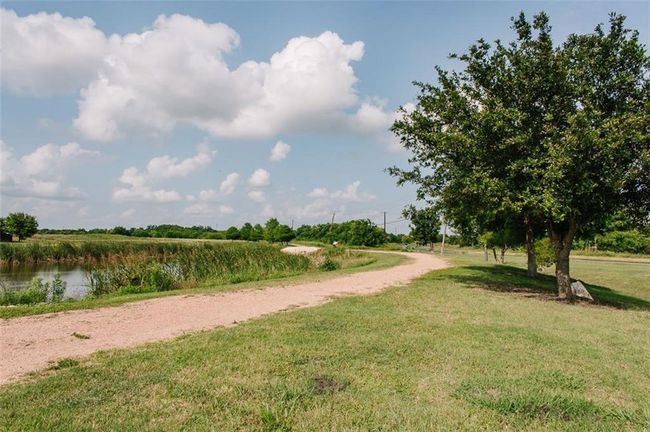 View of community featuring a lawn | Image 23