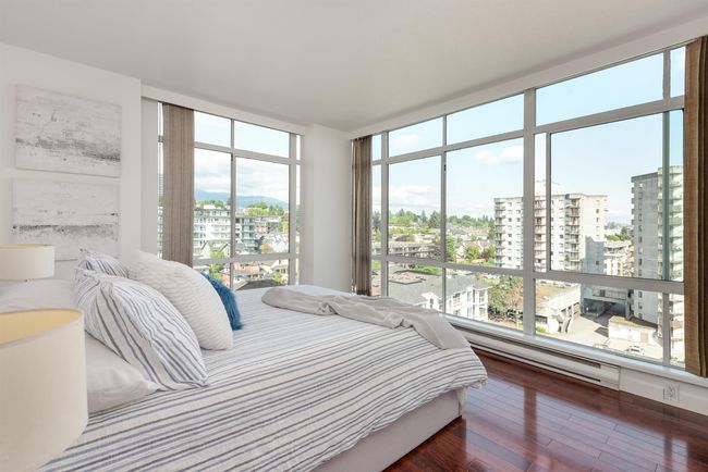 Bedroom featuring a city view, wood-type flooring, and a baseboard heating unit | Image 31