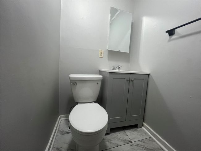 Bathroom with marble finish floors, baseboards, toilet, and vanity | Image 7
