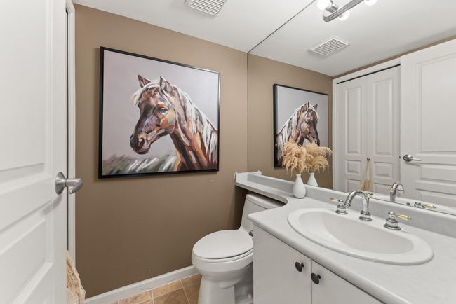 Half bathroom with vanity, tile patterned floors, toilet, and baseboards | Image 26