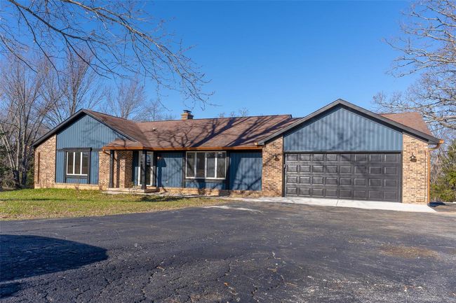 View of front of house featuring a garage | Image 13