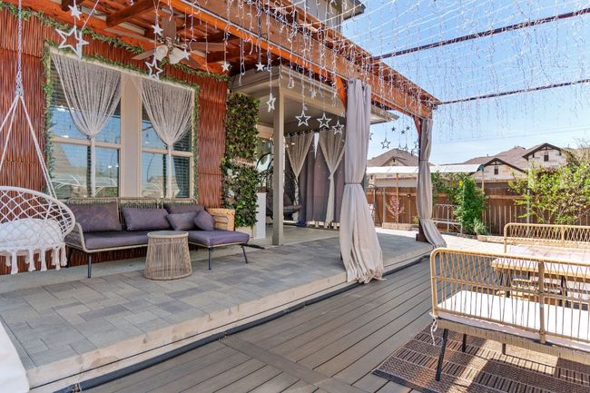 Wooden terrace with outdoor lounge area, fence, and a ceiling fan | Image 34