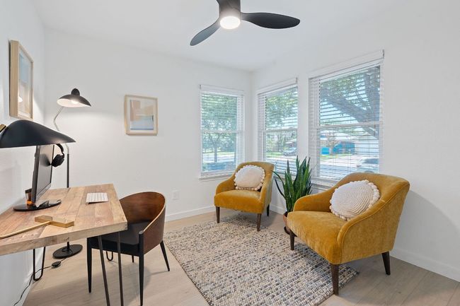 Home office with a ceiling fan and light wood-style floors | Image 17
