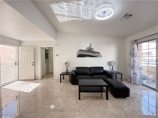 Living area featuring visible vents, marble finish floor, and baseboards | Image 8
