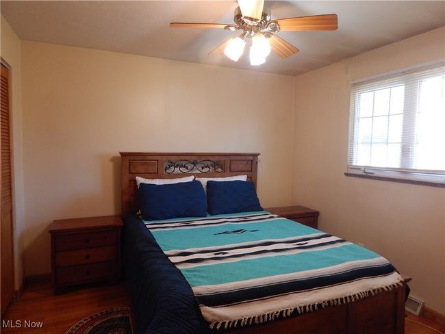Bedroom with wood finished floors, a ceiling fan.& nice closet. | Image 21