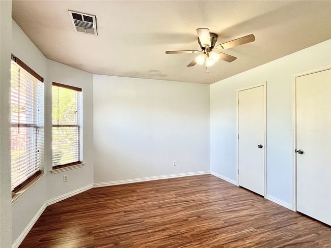 Unfurnished bedroom with wood finished floors and a ceiling fan | Image 24