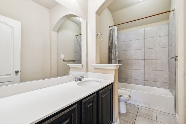 Bathroom featuring tile patterned flooring, toilet, vanity, and shower / bath combo | Image 21